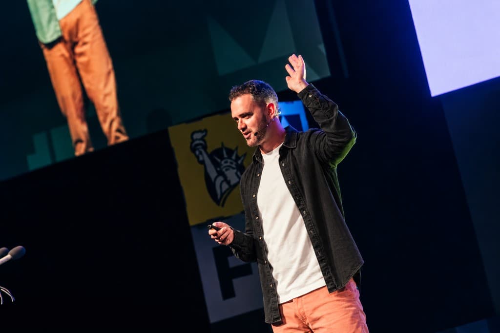 Rob O'Shaughnessy speaking on stage